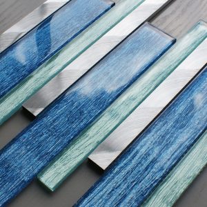 portland blue linear mixed mosaic tiles. Coming a mix of light blue and dark blue with brushed silver metal mosaic tiles mixed in. Sheet size is 40x30cm